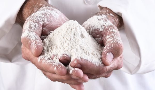 closeup-of-a-chef-holding-a-two-handfuls-of-flour-2025-10-16-06-19-36-utc